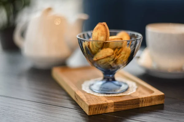 Russian walnut cookies stuffed with condensed milk in glass bowl in a restaurant with blurred background. — Stock Photo, Image