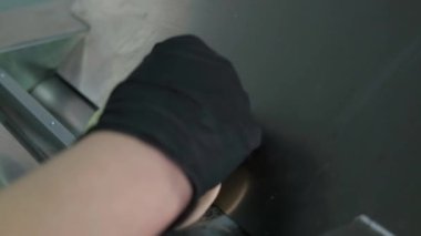 Close up hands of chef roll out dough with help of machine for rolling dough. The process of making khinkali in kitchen.