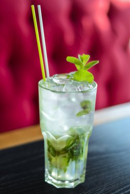 Green Mohito colorful refreshing cocktail with ice and lime. Fruit tropical mix drink.