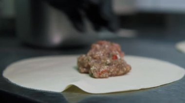 Yemek video konsepti. Aşçı khinkali yapıyor. Ulusal Gürcü mutfağı. Hamura et koyup khinkali yapıyorum..