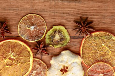 Dried orange, lemon, cinnamon sticks, anise star on rustic wooden background. Traditional mulled wine with spices.