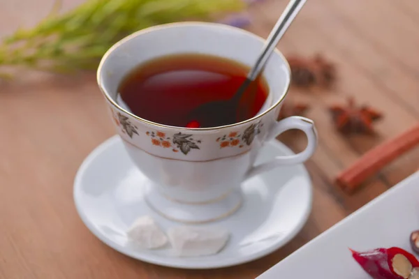 Tasty oriental sweets. Caucasian delicacy churchkhela - georgian nut treats. Served with a glass of tea and a tea pot. — Stock Photo, Image