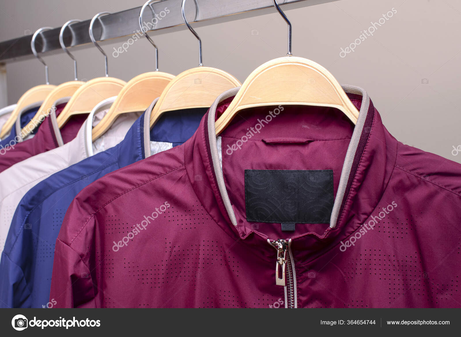 Row of many different colorful hoodie jackets, sport jackets for