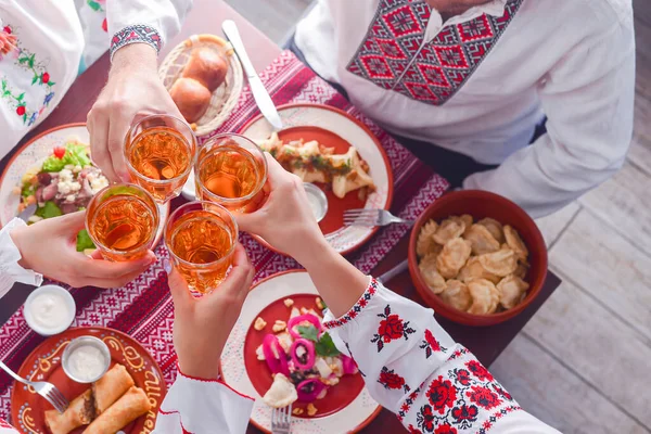 Ukrainian family in traditional closes has a dinner together. Ukrainian culture. Ukraine concept. Holiday concept. — Stock Photo, Image