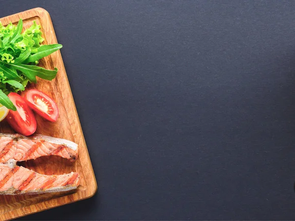 Grilled salmon steak with sea salt and pepper. Fresh fish. Top view, copy space. Food background. — Stock Photo, Image