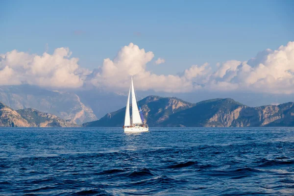 Racing yacht in the sea on blue sky background. Peaceful seascape. Travel concept, travelling.