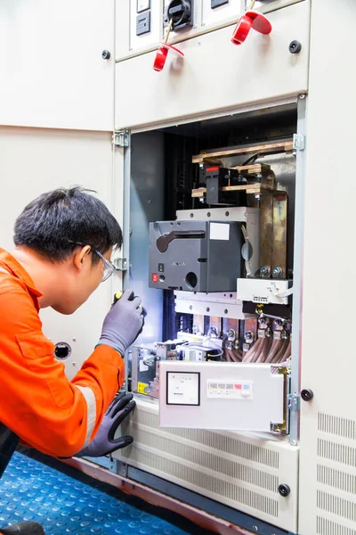 Electrician,Electrician on the job checking main circuit breaker