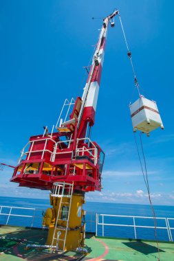 Pedestal crane, crane operator during operate crane with blue sk clipart