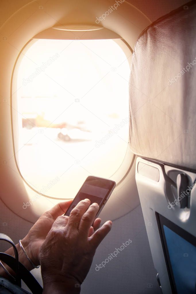 hand with smartphone during flight