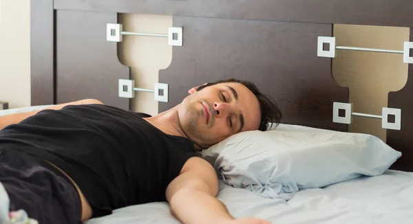 Homem descansando confortavelmente em sua cama pela manhã — Fotografia de Stock