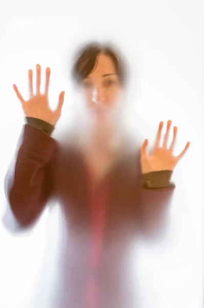 Shadowy woman figure behind a frosted glass — Stock Photo, Image