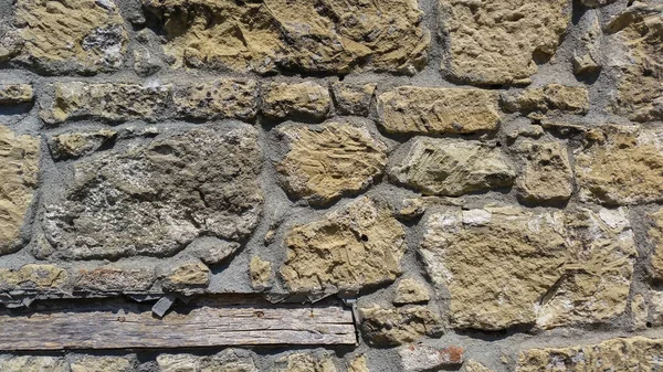 Utsikt över en gammal vägg med gula stenar — Stockfoto