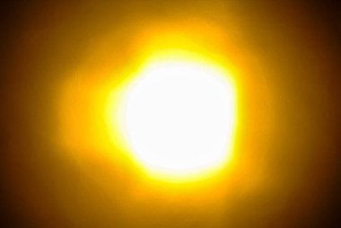 Sarı ve turuncu haleler ile parlak parlayan ışık arka plan