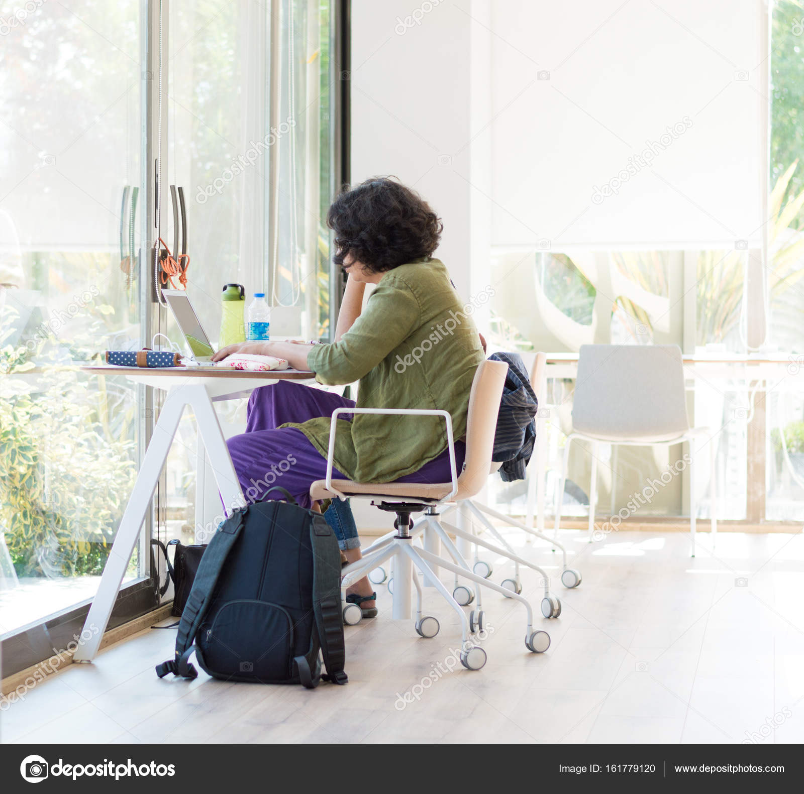 Young College Student Studying With Laptop In The University
