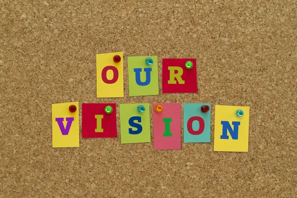 our vision inscription on colorful sticky notes pinned on cork board.