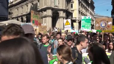 Milan, İtalya - 15 Mart 2019: İklim için küresel grevde yürüyen grevcilerin gösterisi. Protesto panolarına sahip öğrenciler, gelecekteki hareketler için Cuma günü kalabalık, ekoloji geçit törenindeki insanlar, yeşil idealler