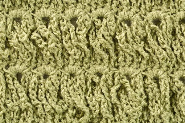Background of woolen threads of olive color.