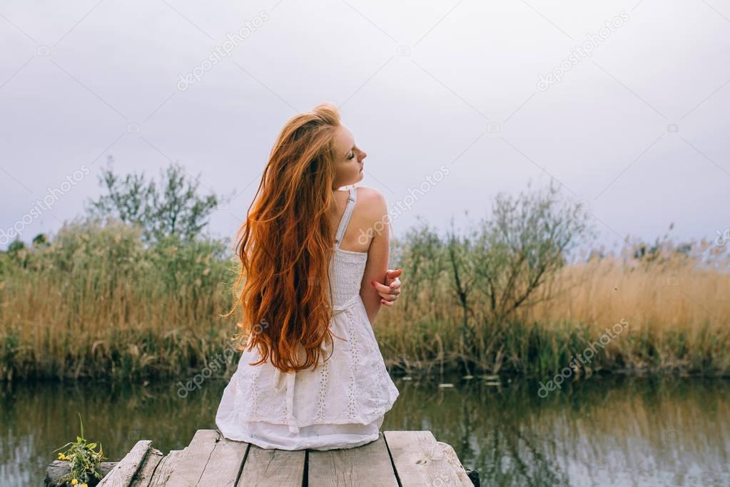 Redhead woman on pier