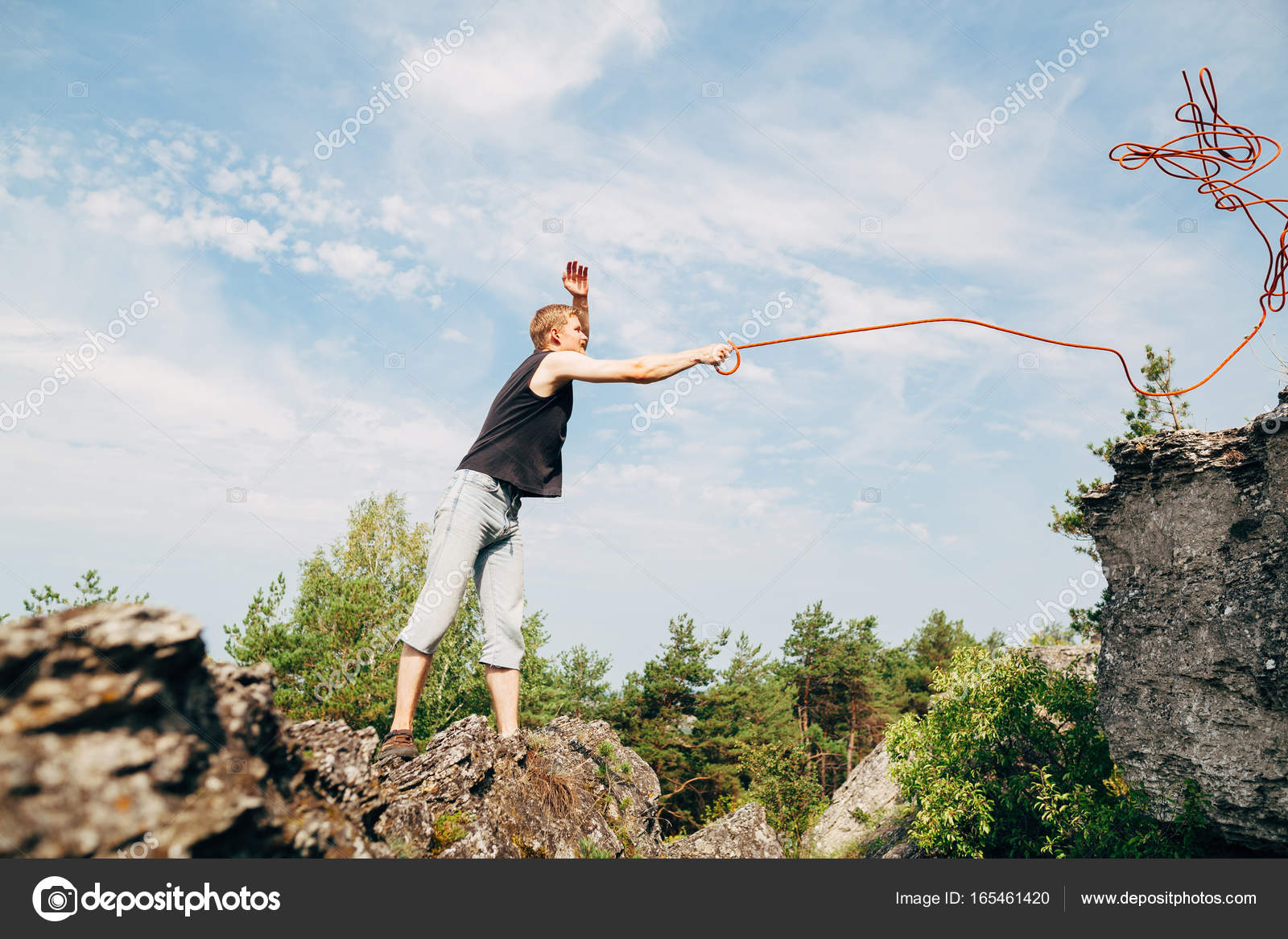 Man throwing rope on rock — Stock Photo © Amvorsuf #165461420