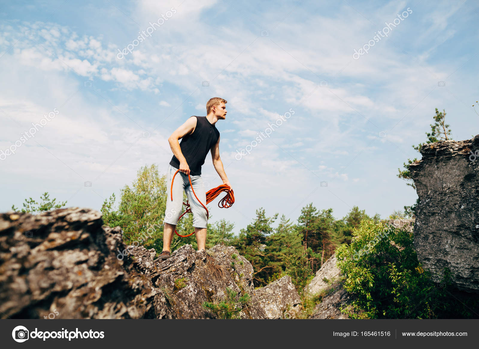 Man throwing rope on rock Stock Photo by ©Amvorsuf 165461516
