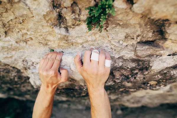 Man climbing up rock