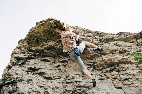 Man climbing up rock