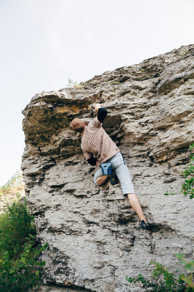 Man climbing up rock