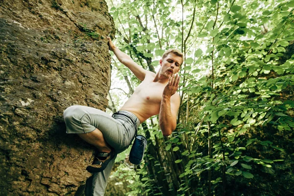 Man climbing up rock