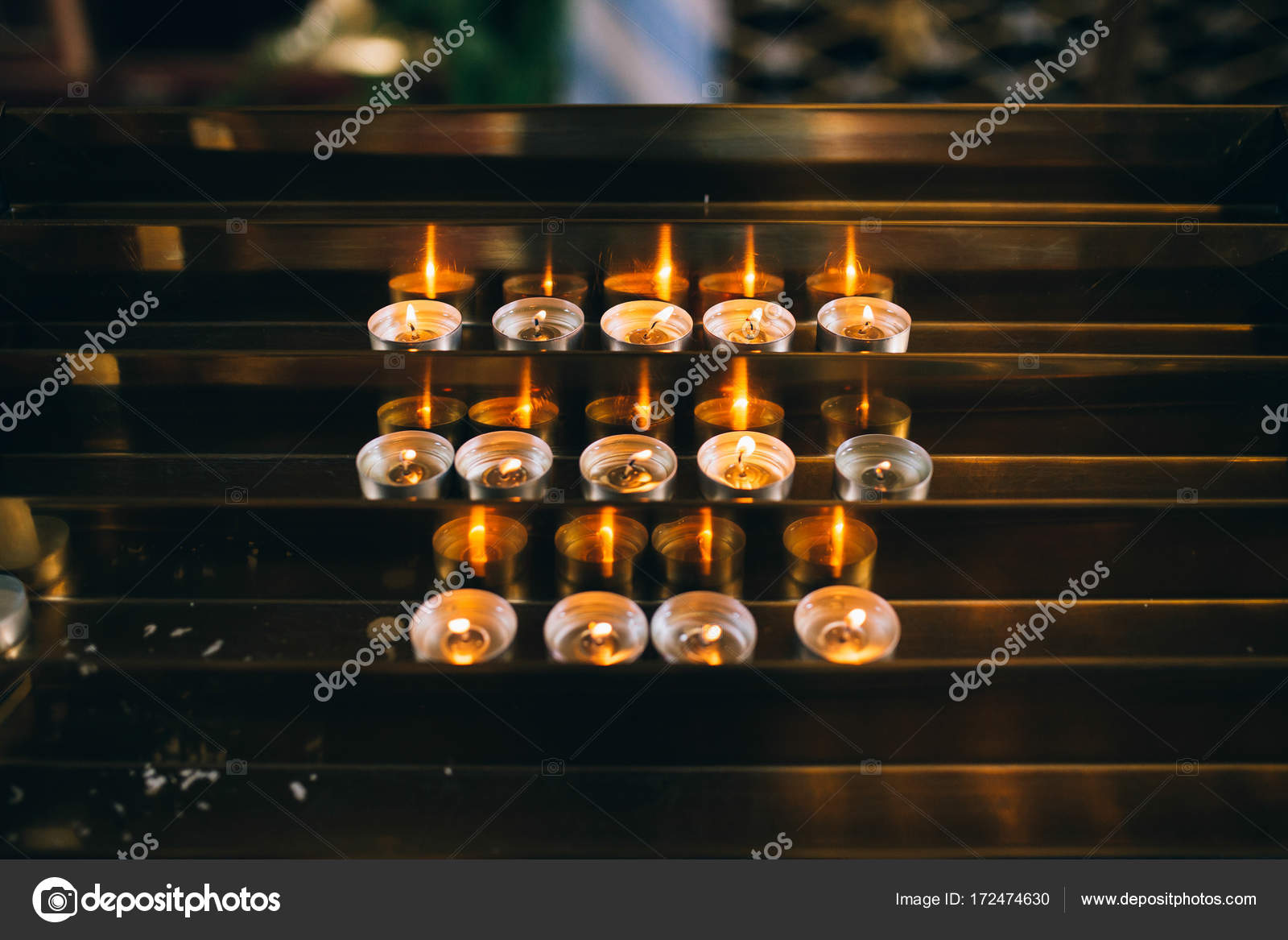 Burning candles on church altar Stock Photo by ©Amvorsuf 172474630
