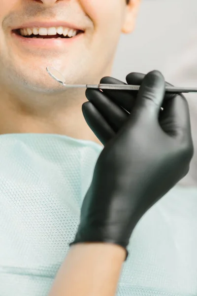 mouth closeup with dentist tools