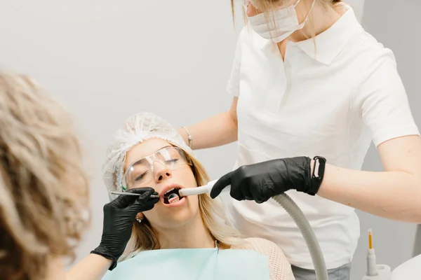 Dental doctors examining patient. Dentists are working.