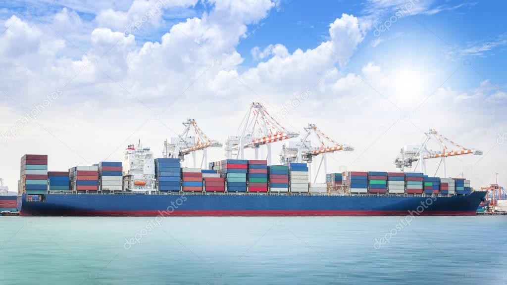 Logistics import export background of Container Cargo ship in seaport on blue sky