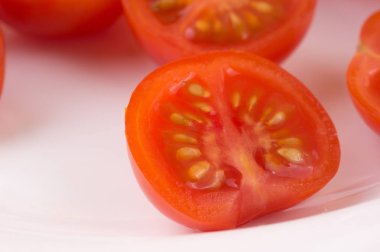 Beyaz bir tabağa dilimlenmiş kiraz domates