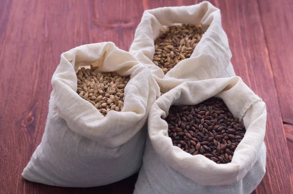 Pale, caramel, chocolate malt in a bags. Craft beer brewing from — Stock Photo, Image