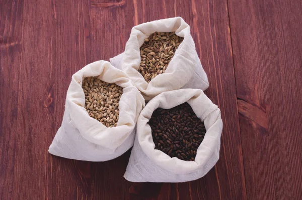 Pale, caramel, chocolate malt in a bags. Craft beer brewing from — Stock Photo, Image