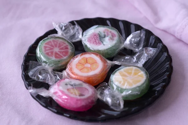 Colorful lollipops and different colored fruit round candy in wr — Stock Photo, Image