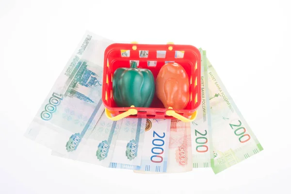 ruble banknotes, plastic shopping basket with toy plastic food,