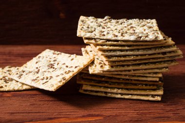 Stack of crispy wheat cakes with sesame seeds, flax and sunflowe