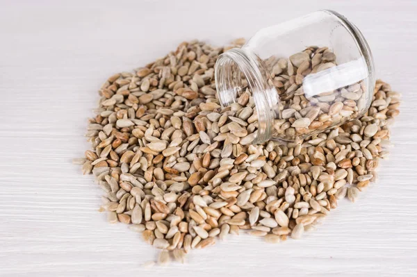 Sunflower seeds in a jar  on white wooden background. vegetarian — Stock Photo, Image