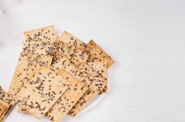 crispy wheat cakes with sesame, flax and sunflower seeds on plat