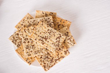 crispy wheat cakes with sesame, flax and sunflower seeds on plat