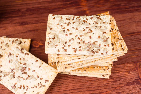 Stack of crispy wheat cakes with sesame seeds, flax and sunflowe — Stock Photo, Image