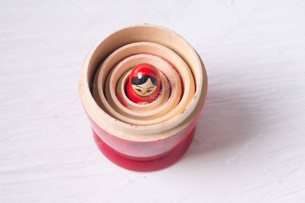 folk toy called a nesting doll embedded in the uncovered upper layers of the toy