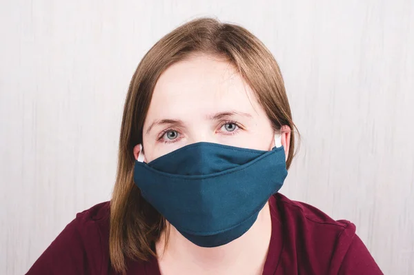 Woman wearing protection handmade face mask against coronavirus.