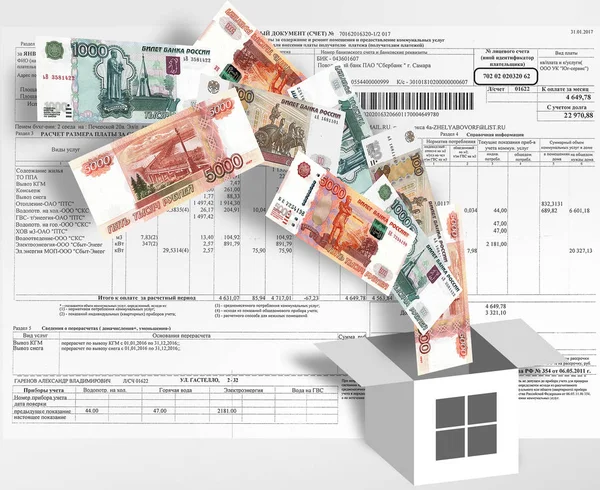 The introduction of the rent. Money flying in the symbolic box-house on the background of the payment receipt.