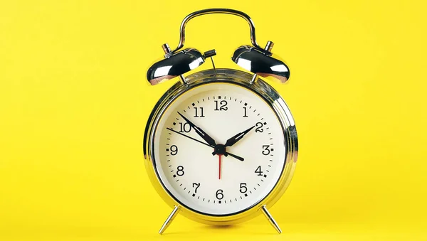 Steel Silver Alarm Clock In Retro Style On A Bright Yellow Background. Banner.