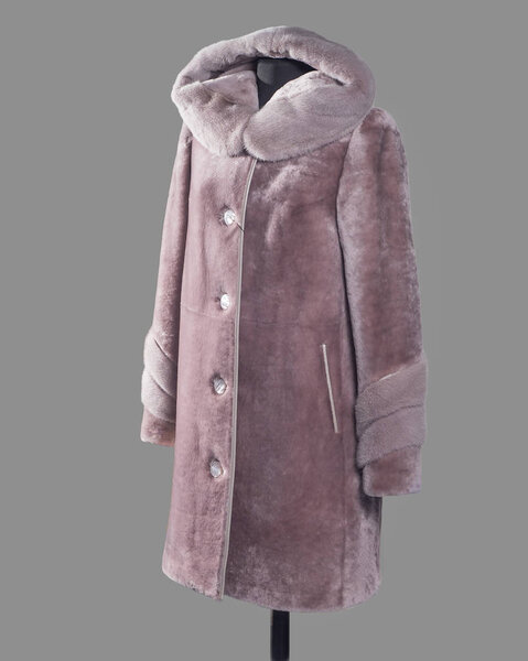 Coat straight silhouette pink-powder color of Mouton and mink trim on the edge of the hood and sleeves, slanting pockets with leather trim. Vertical frame