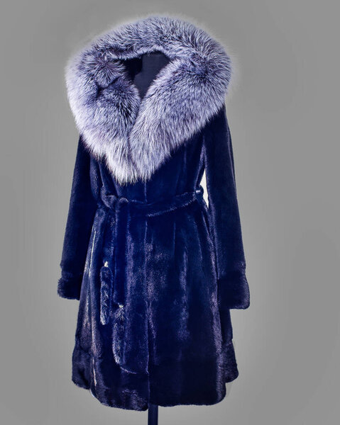 Fitted mink coat with a belt and a hood trimmed with fox fur for the catalog