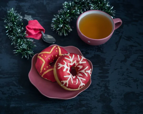 Sweet Breakfast on Christmas morning, cakes with white icing and green tea served in pink crockery — Stock Photo, Image