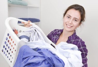 Young woman with basket full of male shirts clipart